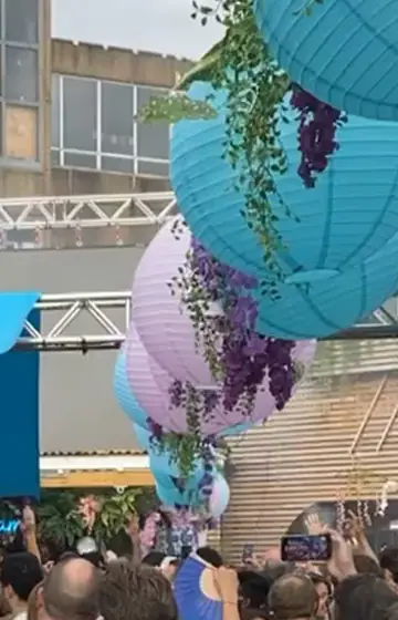 Lanterns and teal sails over a day-party crowd