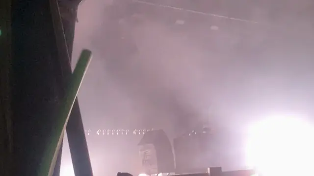 A smoky forest stage with a green laser at Lost Village