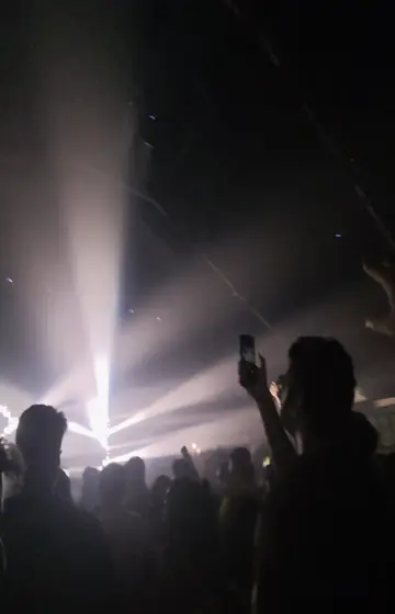 White beams over a dark club crowd